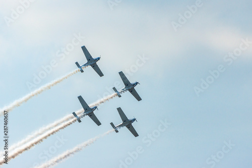 Airplanes on airshow. Aerobatic team performs flight at air show