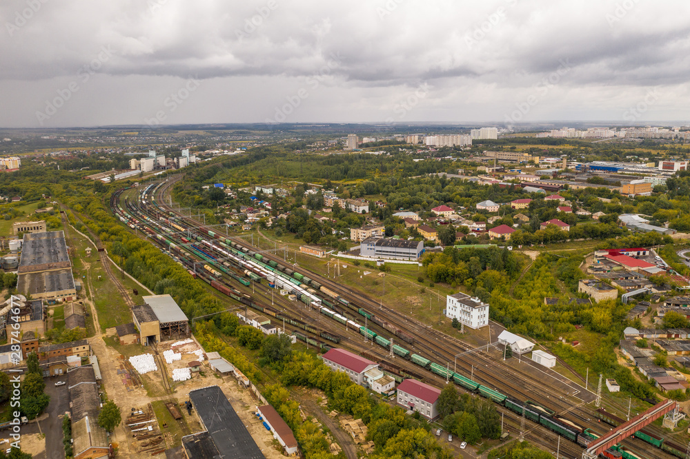 Industrial area with cargo trains on railroad, aerial view from above