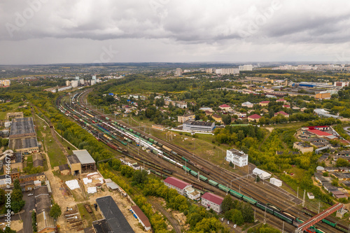Industrial area with cargo trains on railroad, aerial view from above