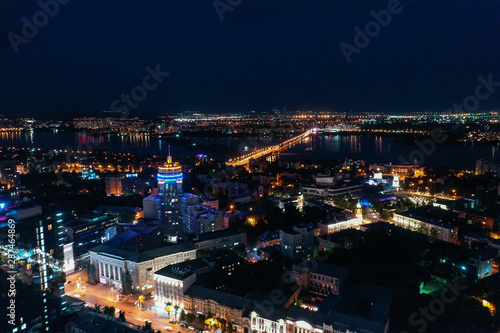 Night City Voronezh downtown or center panorama from above with illuminated road intersection, car traffic, modern business and residential buildings