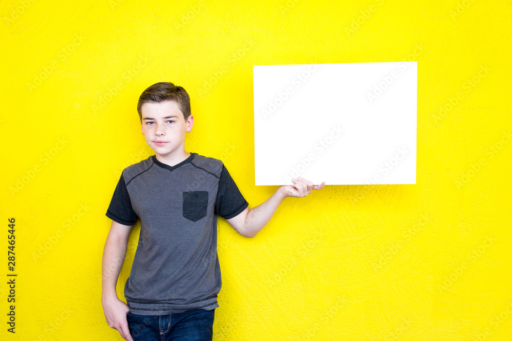 young man holding blank sign young man holding blank sign
