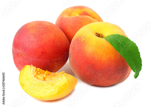 peach fruit with green leaves and slices isolated on white background
