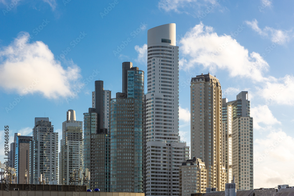 Beautiful view of modern buildings in sunny summer day with blue sky in Puerto Madero, Buenos Aires, Argentina. Modern architecture of office skyscraper and city apartments.