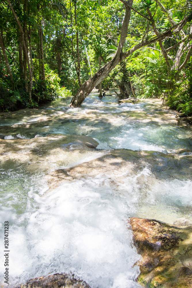 Fototapeta premium Downward flow of turquoise water fall