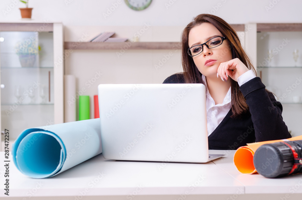 Female designer working in the office Female designer working in the office