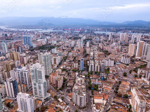 Beautiful aerial drone view of Santos city in Sao Paulo, Brazil. Skyline with buildings, streets, squares and apartments with river channell to the Port of Santos in the background. photo