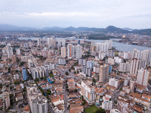 Beautiful aerial drone view of Santos city in Sao Paulo, Brazil. Skyline with buildings, streets, squares and apartments with river channell to the Port of Santos in the background. photo