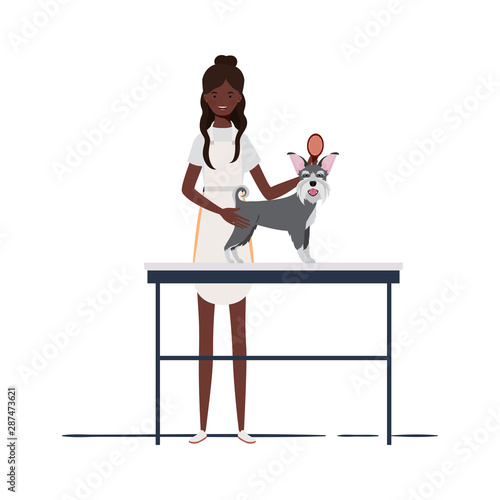young woman combing a dog in pet groomer