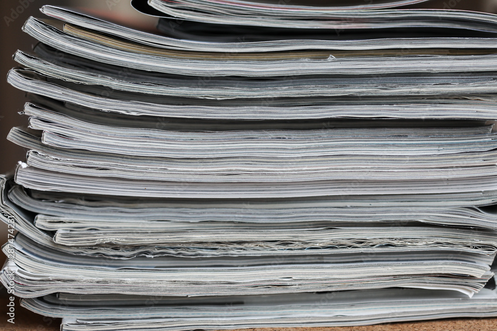 A stack of magazines, close-up macro filled the frame. A background for publishing or informational articles. A stack of magazines, close-up macro filled the frame. A background for publishing or informational articles.