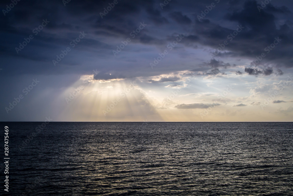 Sunset rays shining over the ocean