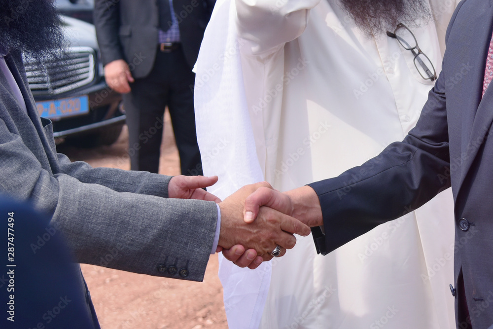 Multicultural business people meeting and talking about business. Shaking hands. Multi-ethnic and Diverse Business People Shaking Hands. Business deal handshake with Arabic and European ethnic mans.