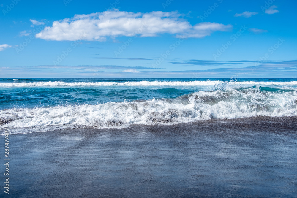 Waves in Atlantic ocean on black sand Beach of Santa Barbara, Sao Miguel Island, Azores, Portugal