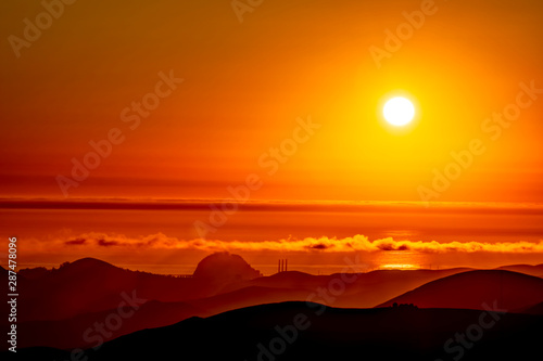 Afternoon Sunset over Ocean, Mountains, Hills