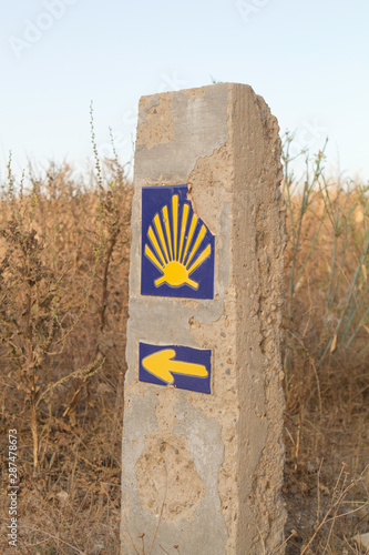 Sign of Camino de santigo. Via de la Plata. Andalusia. Desert landscape. Vertical view photo