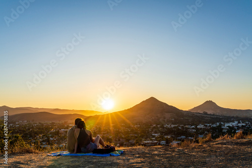 Silhouetted Couple at Sunset, City, Mountains
