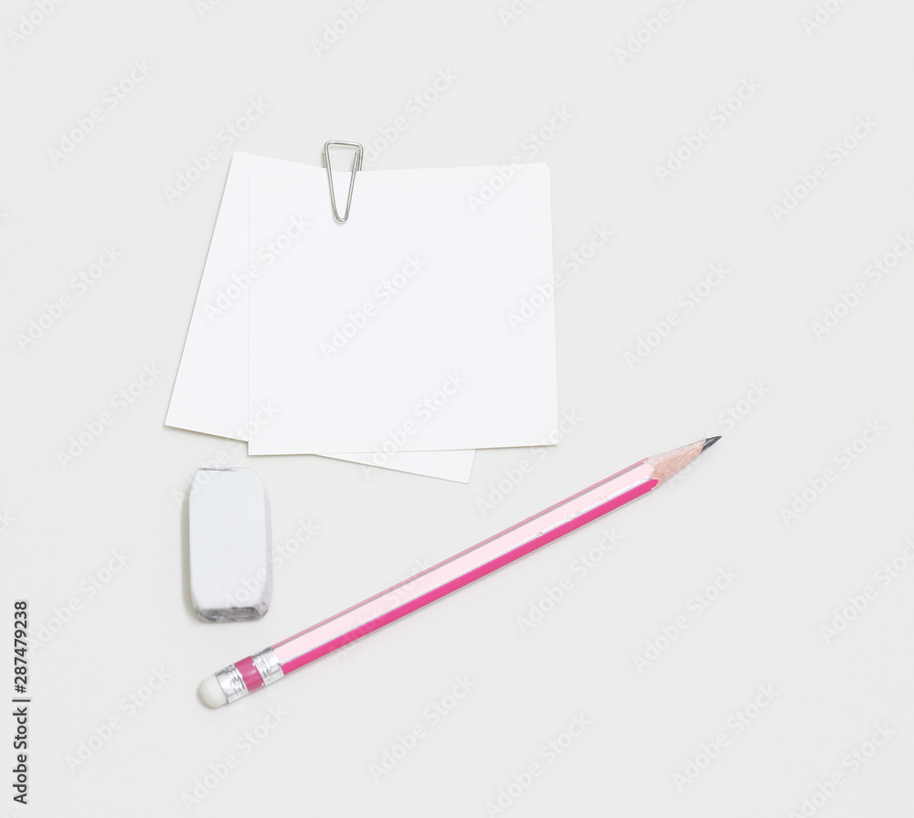 blank white paper with paperclip, pencil and eraser blank white paper with paperclip, pencil and eraser