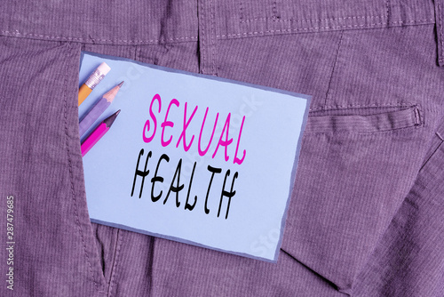 Conceptual hand writing showing Sexual Health. Concept meaning positive and respectful approach to sexual relationships Writing equipment and blue note paper in pocket of trousers