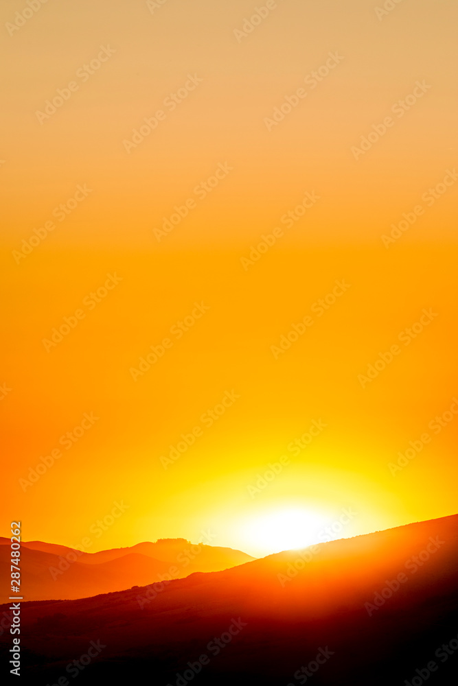 Glow of Sun, sunset, silhouetted Horizon