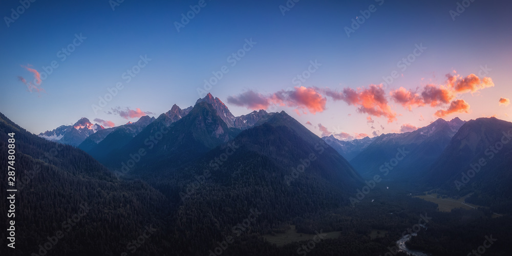Panoramic nature mountains landscape in the sunset. Aerial drone view from above