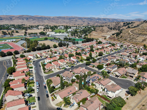 Vászonkép Aerial view of small neighborhood with dry desert mountain on the background in