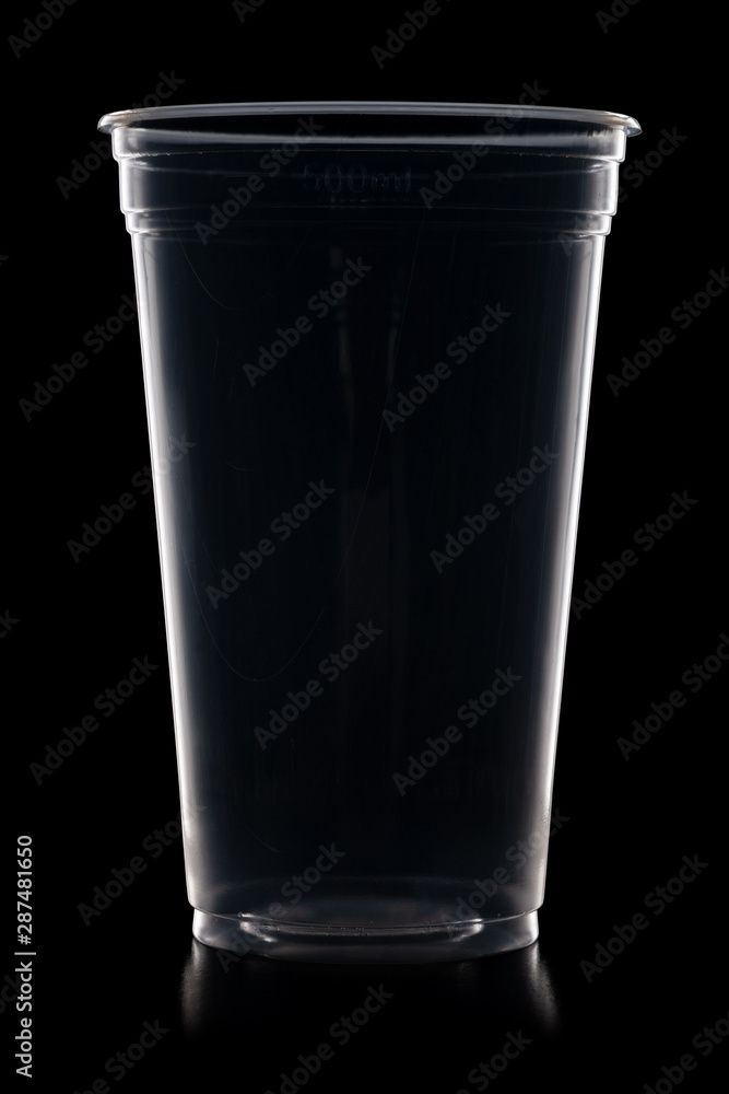 Disposable plastic cup isolated on black background Disposable plastic cup isolated on black background