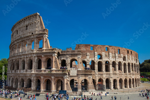 Tourists visiting the famous Colosseum in Rome in a beautiful early spring day