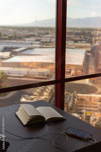 Photography book on top of a table by the window.