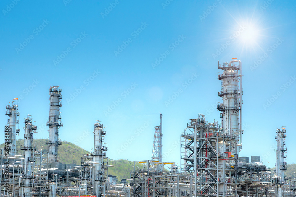 Oil and gas industrial,Oil refinery plant form industry,Refinery factory oil storage tank and pipeline steel with sunset and cloudy sky background,Thailand