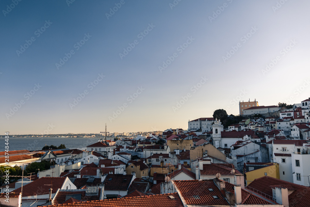 Aerial view of portuguese orange roofs and houses along the sea at sunset in the southern europe, Porto, Portugal