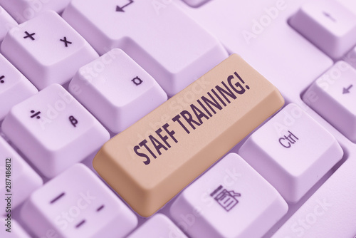 Conceptual hand writing showing Staff Training. Concept meaning learn specific knowledge improve perforanalysisce in current roles White pc keyboard with note paper above the white background photo