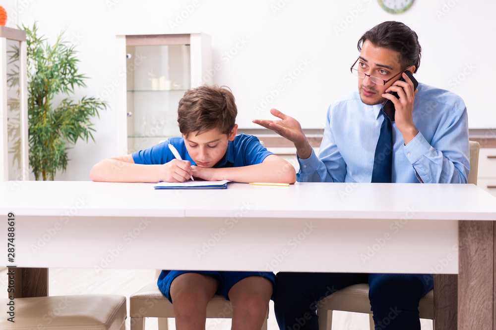 Busy father helping his son to prepare for exam Busy father helping his son to prepare for exam