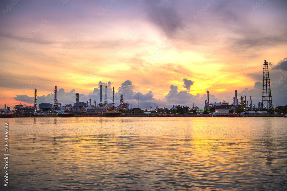 Oil and gas Refinery tower in petrochemical industrial plant with cloudy sky at the Chaophaya river in Bangkok Thailand