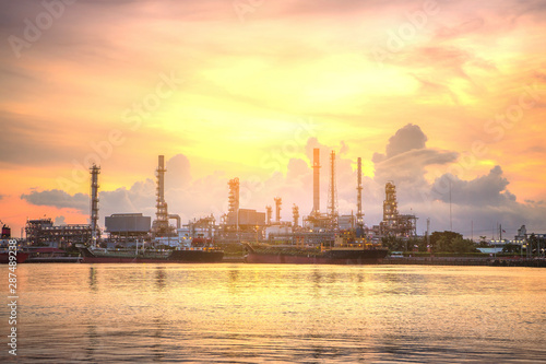 Oil and gas Refinery tower in petrochemical industrial plant with cloudy sky at the Chaophaya river in Bangkok Thailand photo