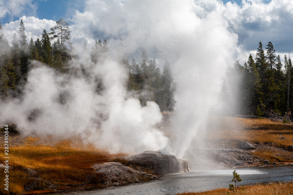 Riverside Geyser erupts over the Firehole River, Upper Geyser Basin, Yellowstone National Park, Wyoming