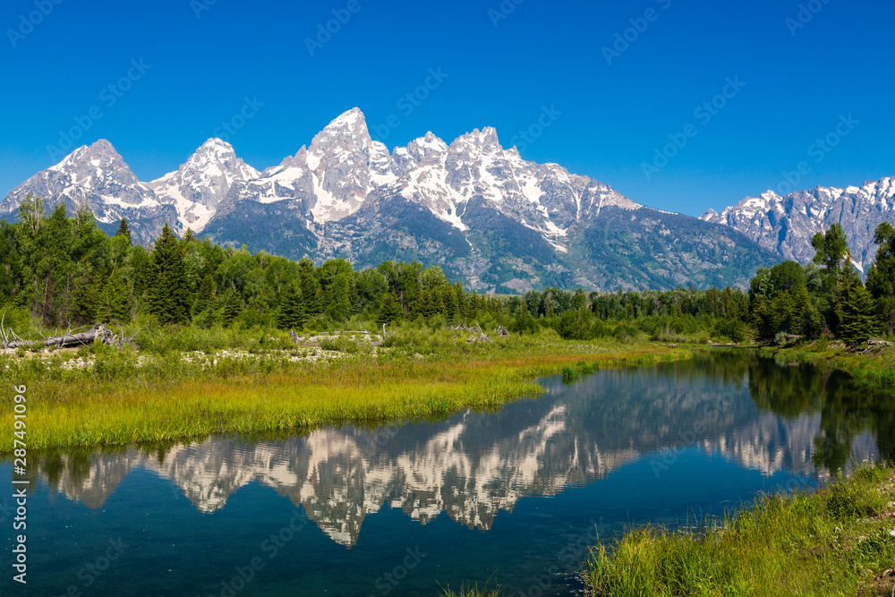 The Tetons reflected in the Snake River at Schwabacher Landing in Grand Teton National Park, Wyoming