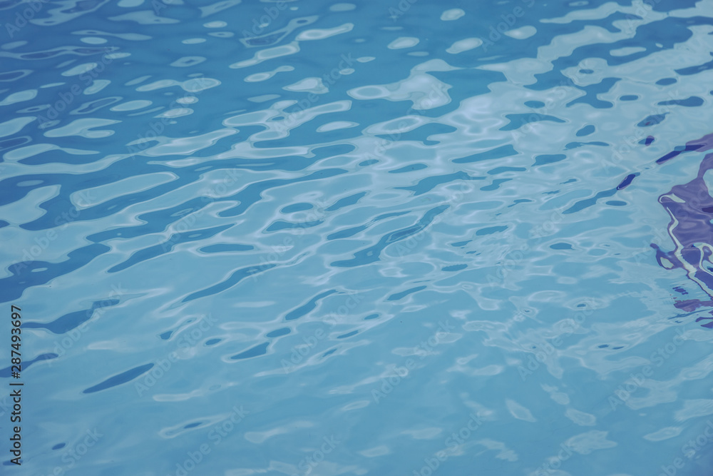 Obraz premium Blue swimming pool edge with refection of water ripple