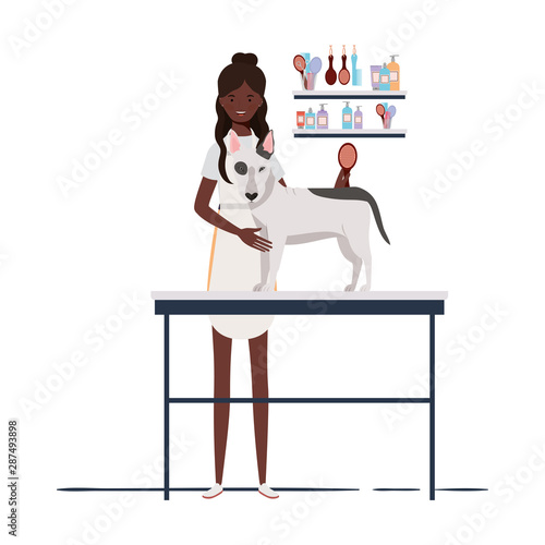 young woman combing a dog in pet groomer