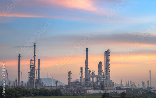 Oil and gas refinery plant form industry petroleum zone Refinery equipment pipeline steel and oil storage tank at sunrise. -image