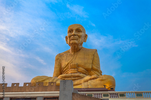 sunrise at the big Buddhist Monks Luang Phor Tuad Statue At Buddha Uttayarn Maharach Project Ayutthaya, Thailand . photo