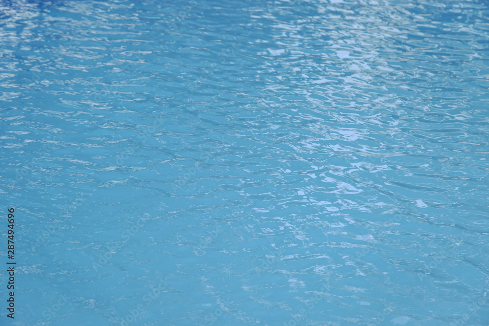 Blue swimming pool edge with refection of water ripple Blue swimming pool edge with refection of water ripple
