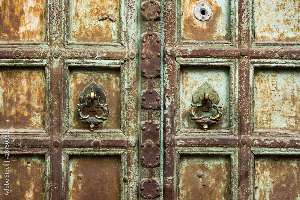 Close-up view of an old decorated wooden door in Jodhpur, Rajasthan, India. Jodhpur is the second-largest city in the Indian state of Rajasthan, India. Close-up view of an old decorated wooden door in Jodhpur, Rajasthan, India. Jodhpur is the second-largest city in the Indian state of Rajasthan, India.