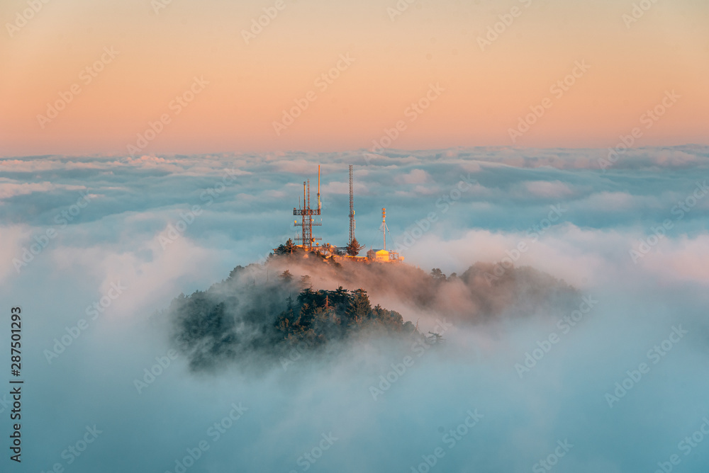 View of marine layer low clouds over Los Angeles at sunset, from Mount Wilson, in Angeles National Forest, California