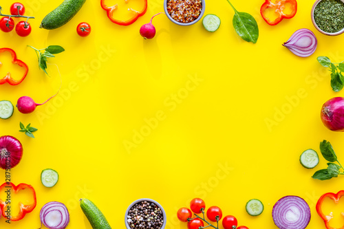 Frame of colorful vegetables on yellow background top view mock up