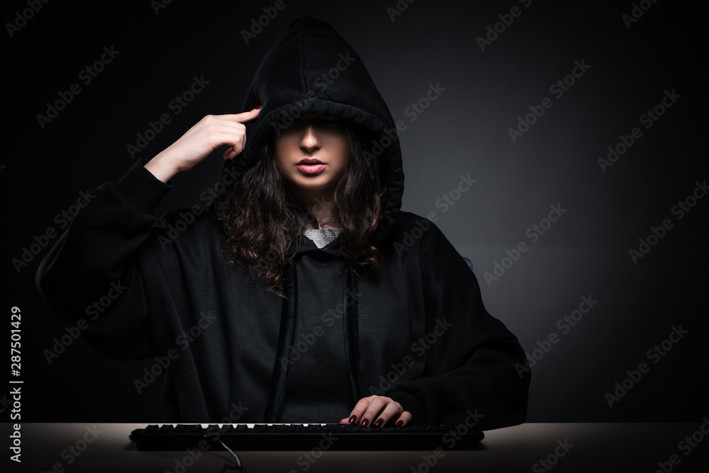 Female hacker hacking security firewall late in office Female hacker hacking security firewall late in office