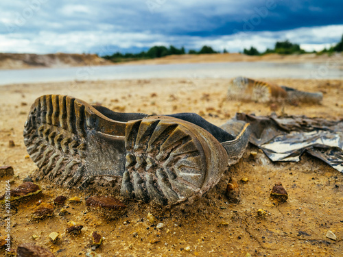 An old Shoe by the lake. Environmental pollution © LesdaMore