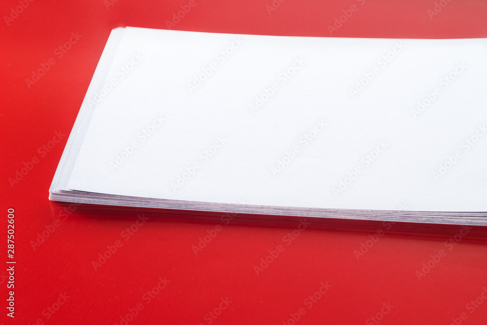 Stack of blank name cards, white empty business card, poster or flyer on red texture. Blank signboard with copy space area for text or slogan Stack of blank name cards, white empty business card, poster or flyer on red texture. Blank signboard with copy space area for text or slogan