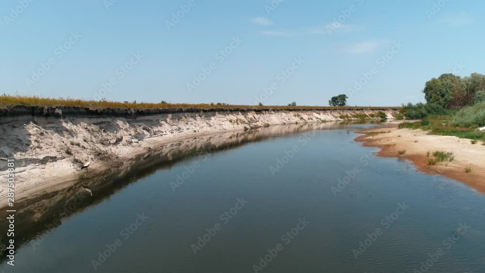 Aerial view of a bird is looking for food on the polluted beach of the dried river, lake. Environmental pollution problem concept. Crane in the wild. Ecological disaster. 4K drone footage. Aerial view of a bird is looking for food on the polluted beach of the dried river, lake. Environmental pollution problem concept. Crane in the wild. Ecological disaster. 4K drone footage.