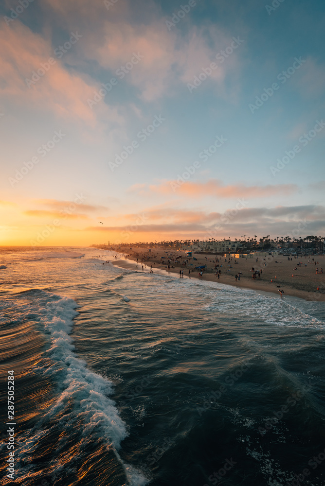 Sunset over the beach from the pier in Huntington Beach, Orange County, California