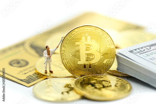 Miniature people : worker painting with Bitcoins ,credit card  of dollar banknote,Digital money cryptocurrency concept. photo