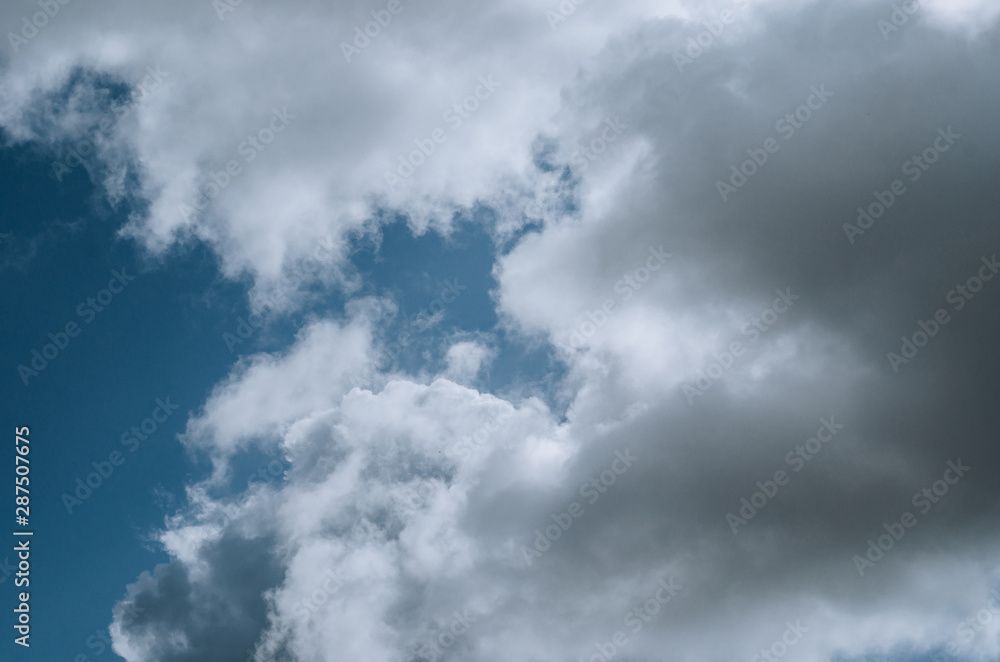 Obraz premium gray rainy clouds against the blue sky